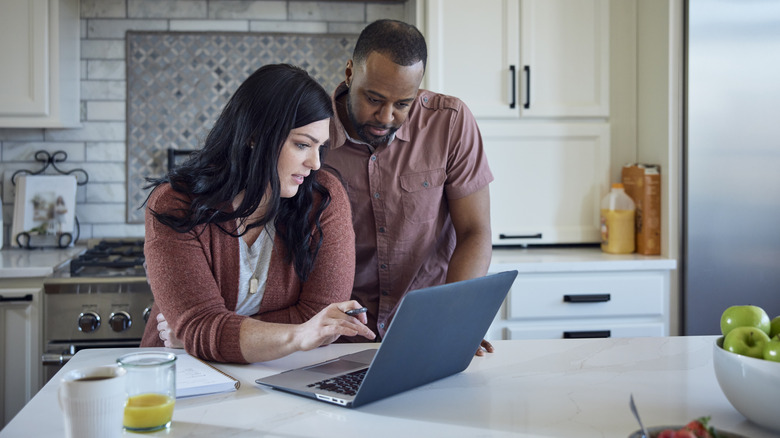 Young couple making plans in large kitchen