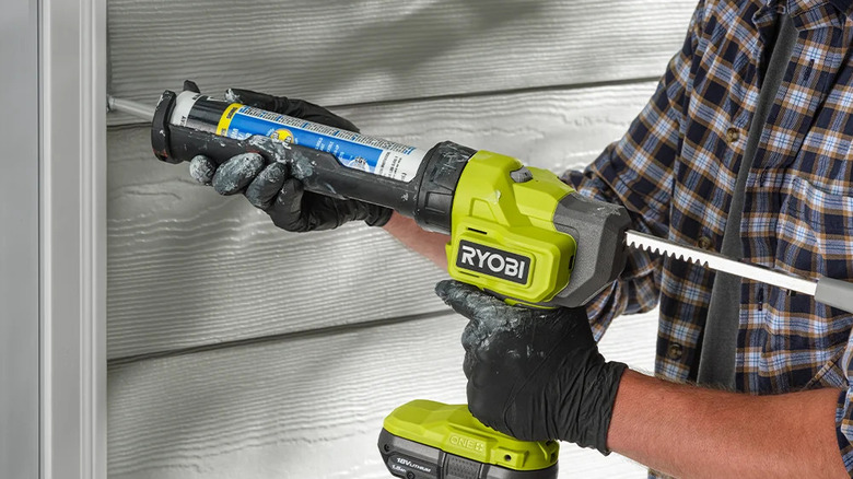 A person caulking an outside door with Ryobi's 18V One+ Cordless 10-ounce Caulk & Adhesive Gun Kit