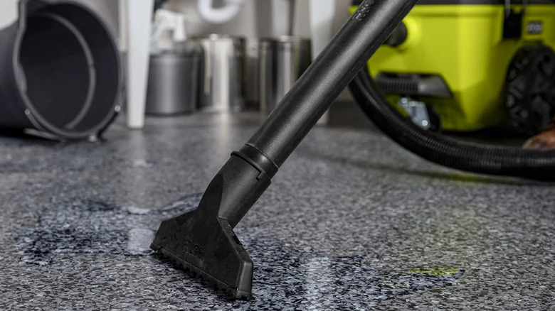 A person clearing up water with Ryobi's 18V One+ Cordless 6-gallon Wet/Dry Vacuum
