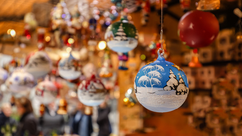 handpainted ornament hanging in front of a market stall