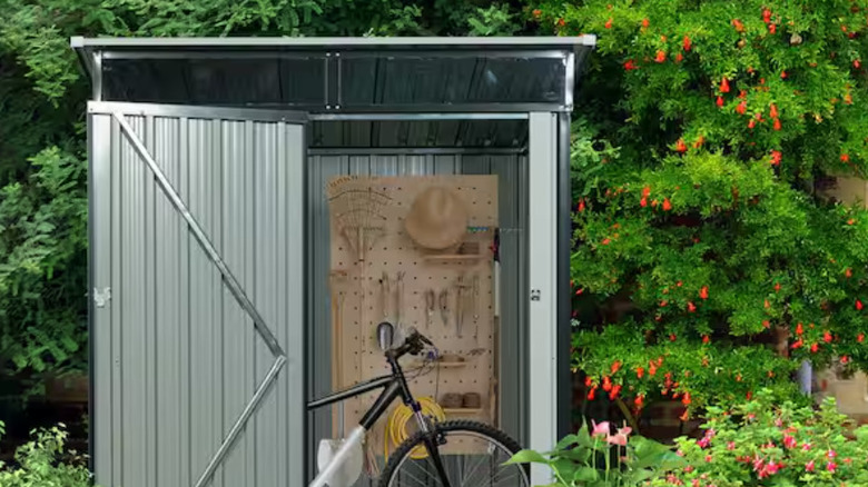 The grey Storhaus metal shed stowing a bike and tools.