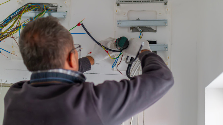 Electrician installs new electrical panel in home