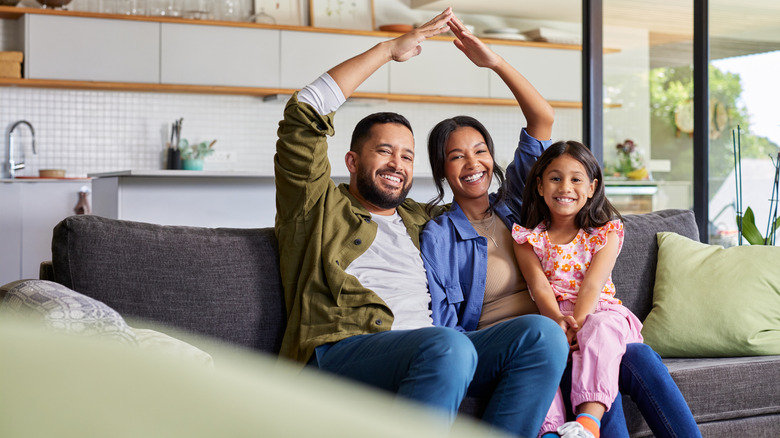 Happy homeowners sitting on their couch
