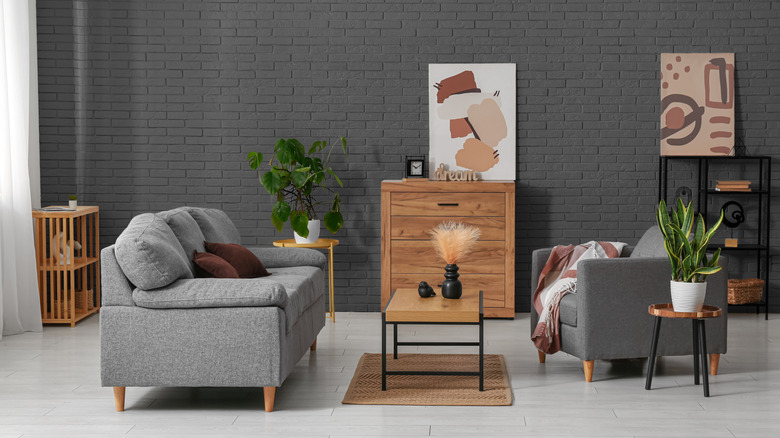 A modern living room with dark gray painted walls.