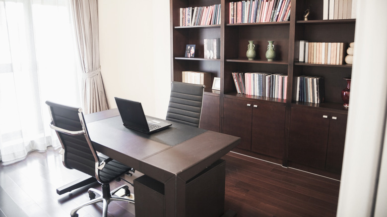 A home office with bookcases and desk.