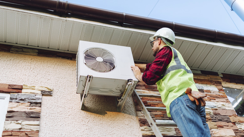 Technician installing a heat pump