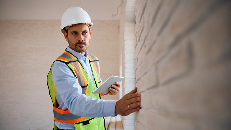 An inspector checking to see if a home needs a retrofit