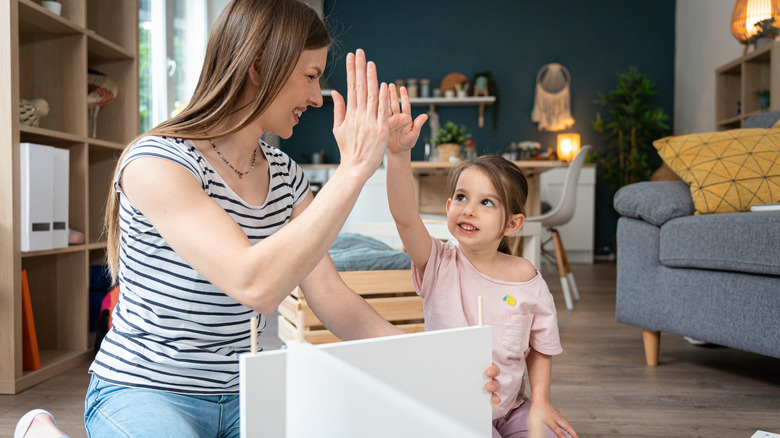 happy mother daughter with furniture