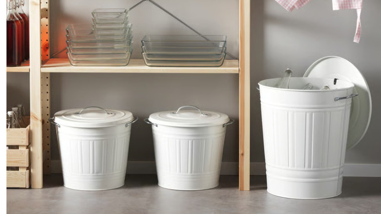 Three white Ikea Knodd bins are underneath some pantry shelving