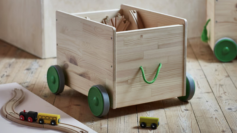An IKEA FLISAT toy storage bin with wheels and a pull-along handle