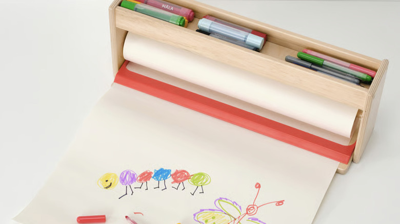 An IKEA MALA paper roll holder with storage compartment