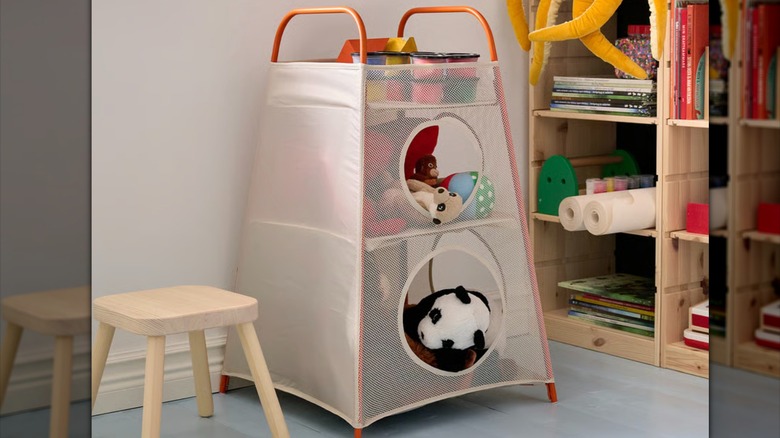 An IKEA TIGERFINK storage unit with compartments, filled with a collection of toys