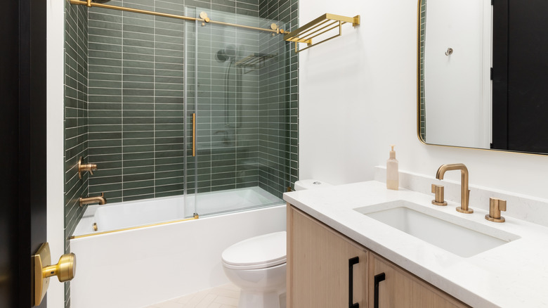 A bathroom with gold hardware