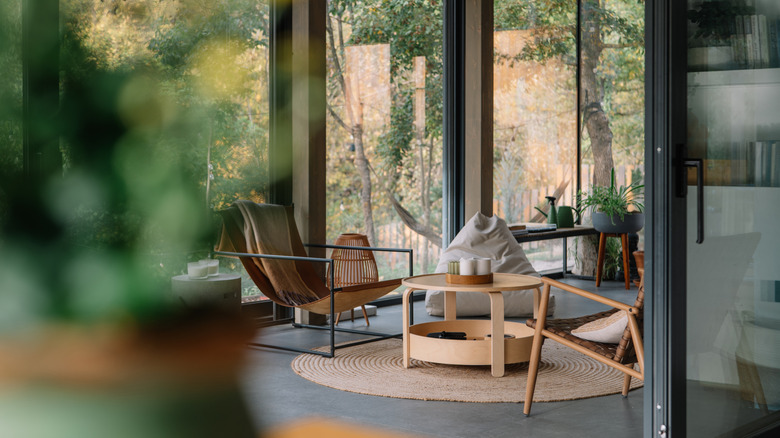 The living room of a modern home with large glass windows