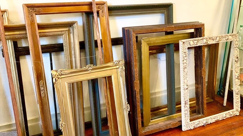Empty vintage frames leaning against a wall