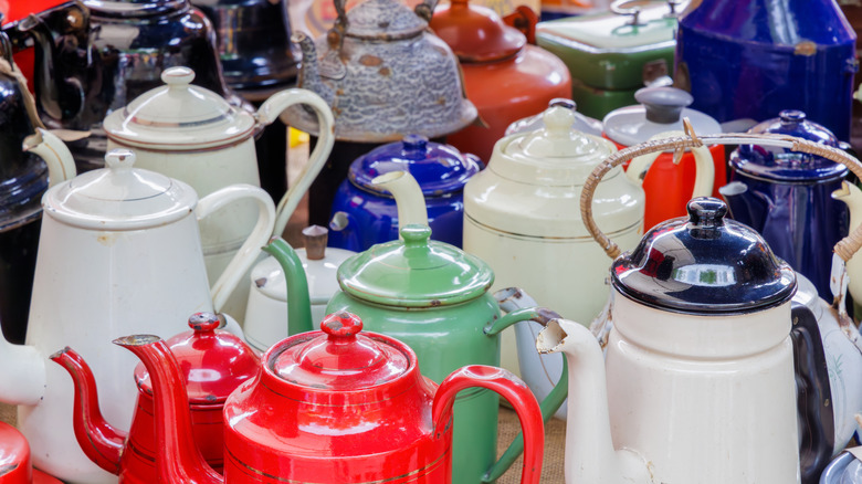 An assortment of colorful vintage tea kettles