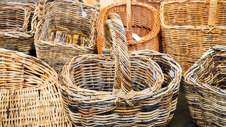 an assortment of woven baskets with price tags