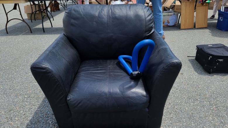 Secondhand leather armchair at garage sale