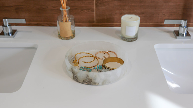 Jewelry tray on a marble bathroom countertop