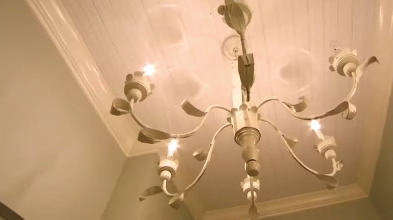 Joanna Gaines designs a small bathroom with multiple light fixtures.