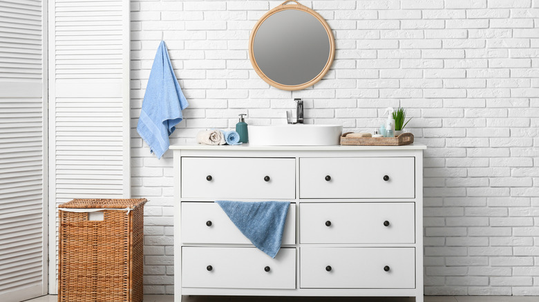 A dresser that's been transformed into a bathroom vanity.