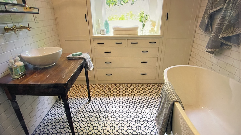 Joanna Gaines uses bold black and white flooring in a bathroom renovation.
