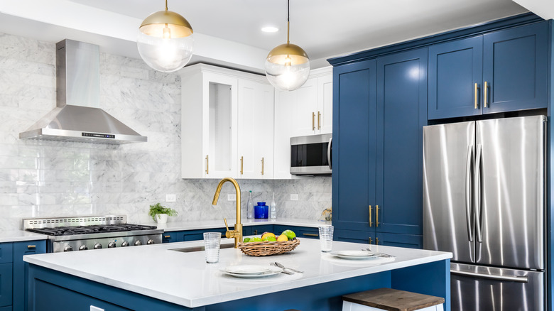 Kitchen with blue cabinets and white countertops