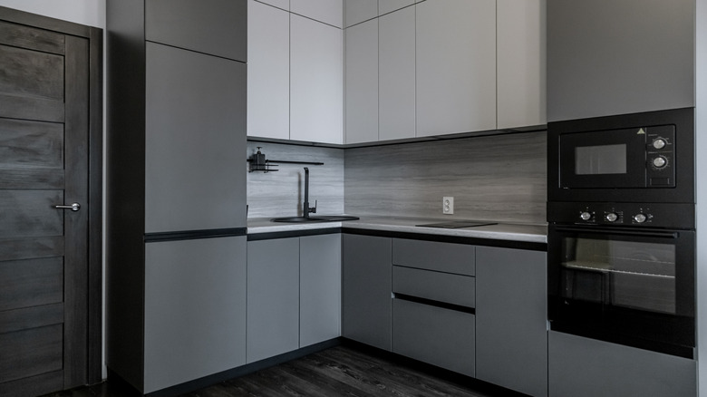 Kitchen with slate gray and white cabinets