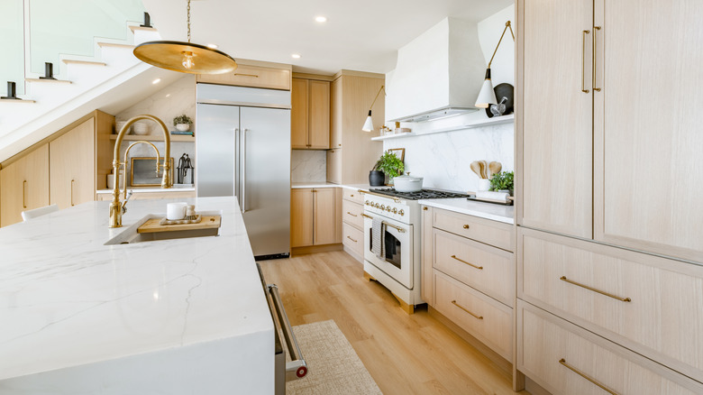 Modern kitchen with warm white accents and light wood cabinets