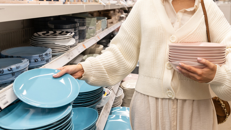 Woman buying colorful plates from a store