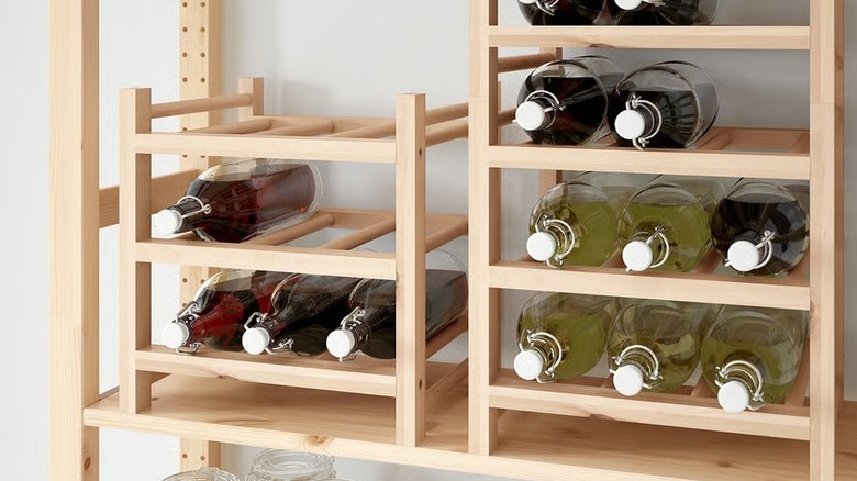 Wood wine racks filled with large colorful bottles