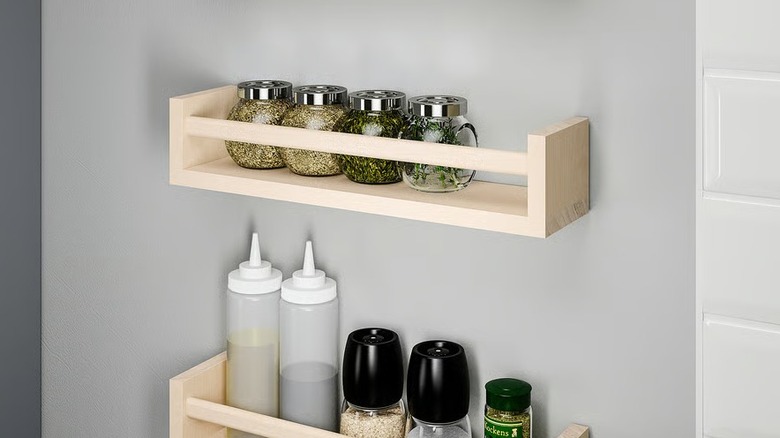 Two spice racks mounted on an empty white wall
