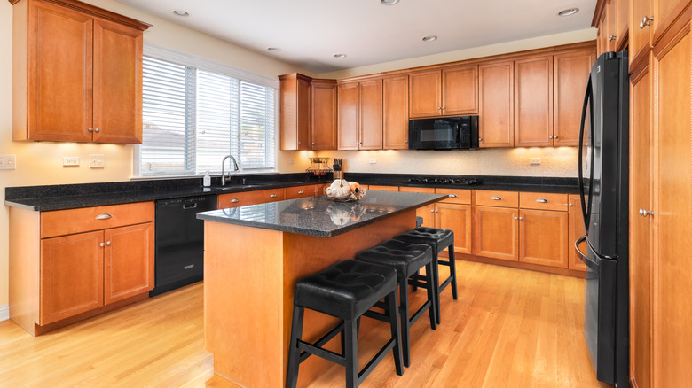 Kitchen island with dark granite countertop