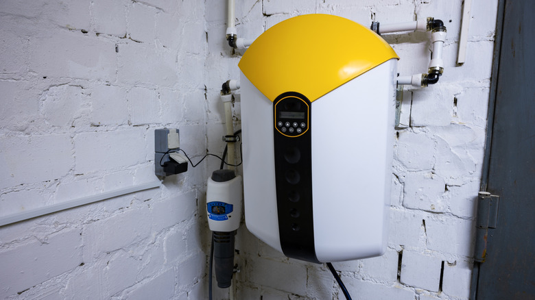 Water softening and descaler system for water treatment mounted to a wall