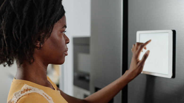 Woman using a smart fridge tablet