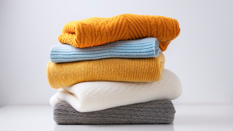 Five woolen garments folded on top of one another