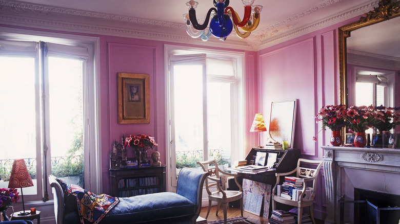 A French ornate living room with pink walls.