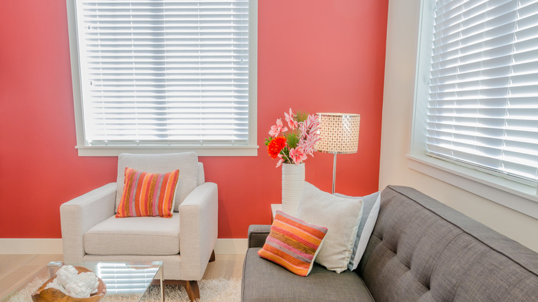 Living room with bright coral walls.