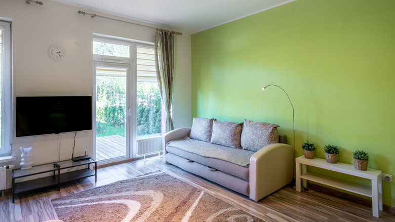 A small living room with a lime green accent wall.