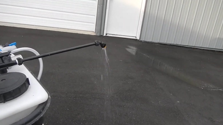 Applying liquid calcium magnesium acetate on a concrete surface
