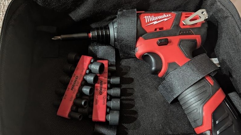 Milwaukee's M12 Lithium-Ion Cordless ⅜-inch Right Angle Drill secured inside a tool bag with velcro straps