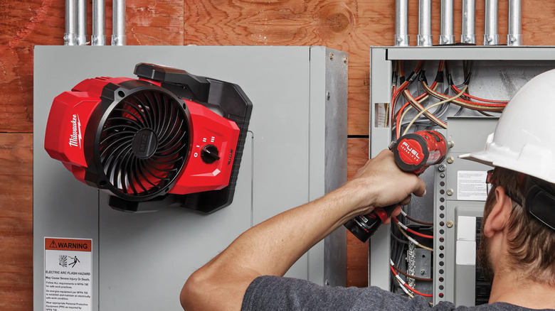 Milwaukee's M12 Lithium-Ion Cordless Jobsite Fan mounted magnetically on an electrical box
