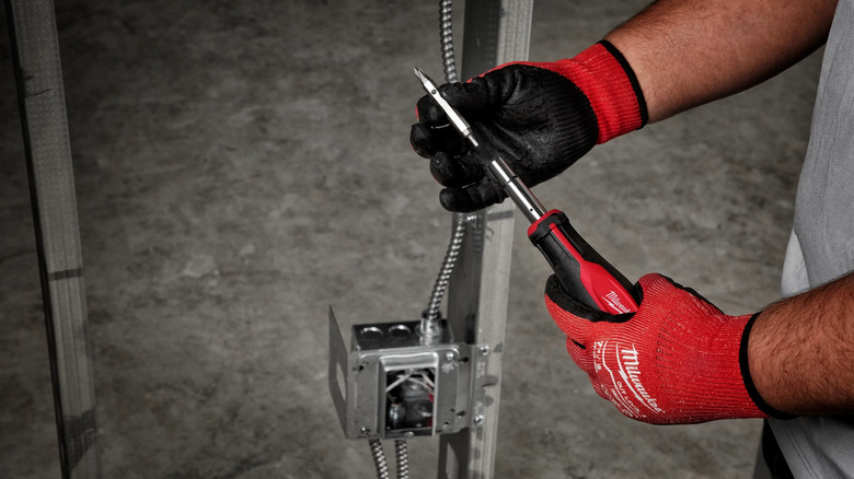 A person switching bits on Milwaukee's 11-in-1 Multi-Tip Combination Screwdriver