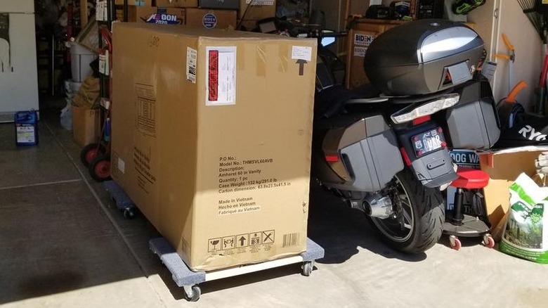A large box mounted on two of Milwaukee's 1,000-pound Capacity Furniture Dollies
