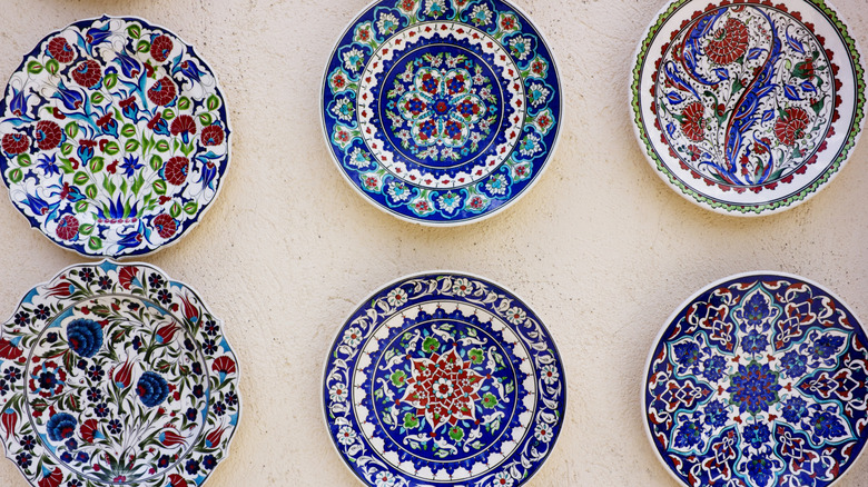 Closeup of six colorful plates hanging on a wall
