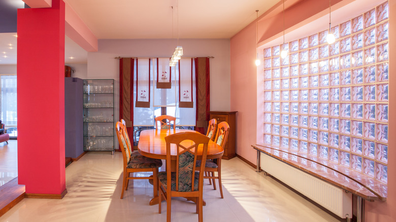 A dining space with a glass block wall