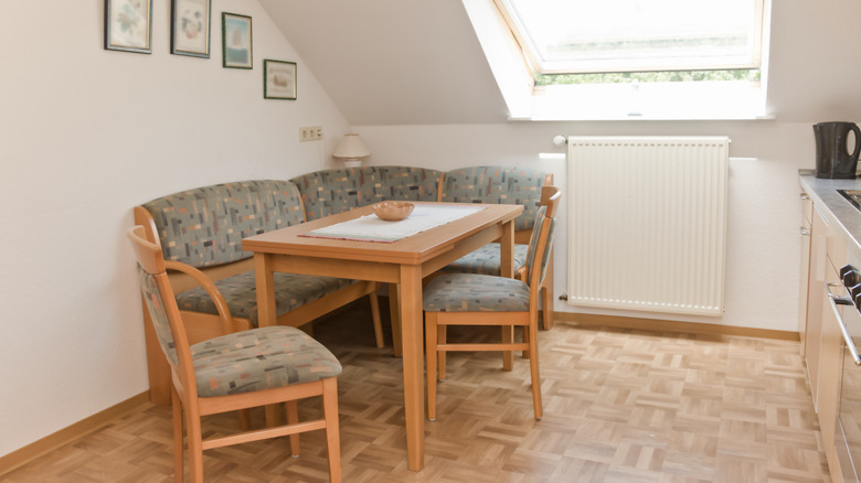 A small dining area with a honey oak dining set