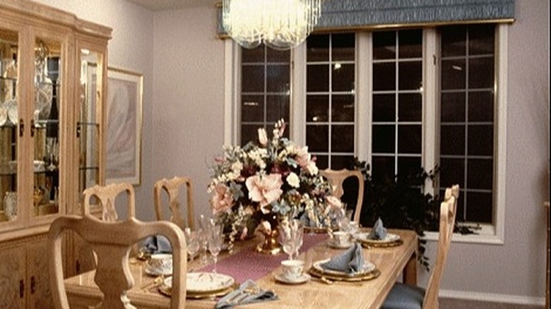 A dining room with fabric repeated on the chairs, valence, and napkins