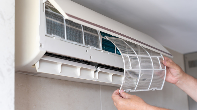 Hands removing AC filters
