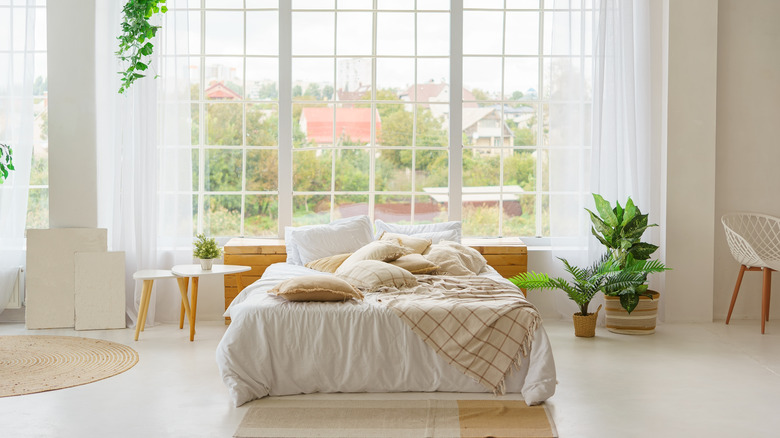 Boho-inspired bedroom with ceiling-to-floor windows
